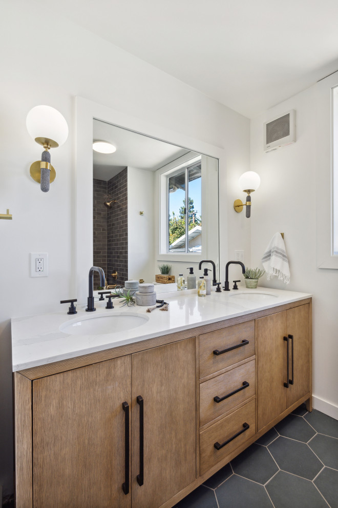 This is an example of a mid-sized transitional kids bathroom in San Francisco with flat-panel cabinets, medium wood cabinets, an alcove tub, a shower/bathtub combo, a one-piece toilet, black tile, subway tile, white walls, ceramic floors, an undermount sink, engineered quartz benchtops, turquoise floor, a shower curtain, white benchtops, a double vanity and a freestanding vanity.