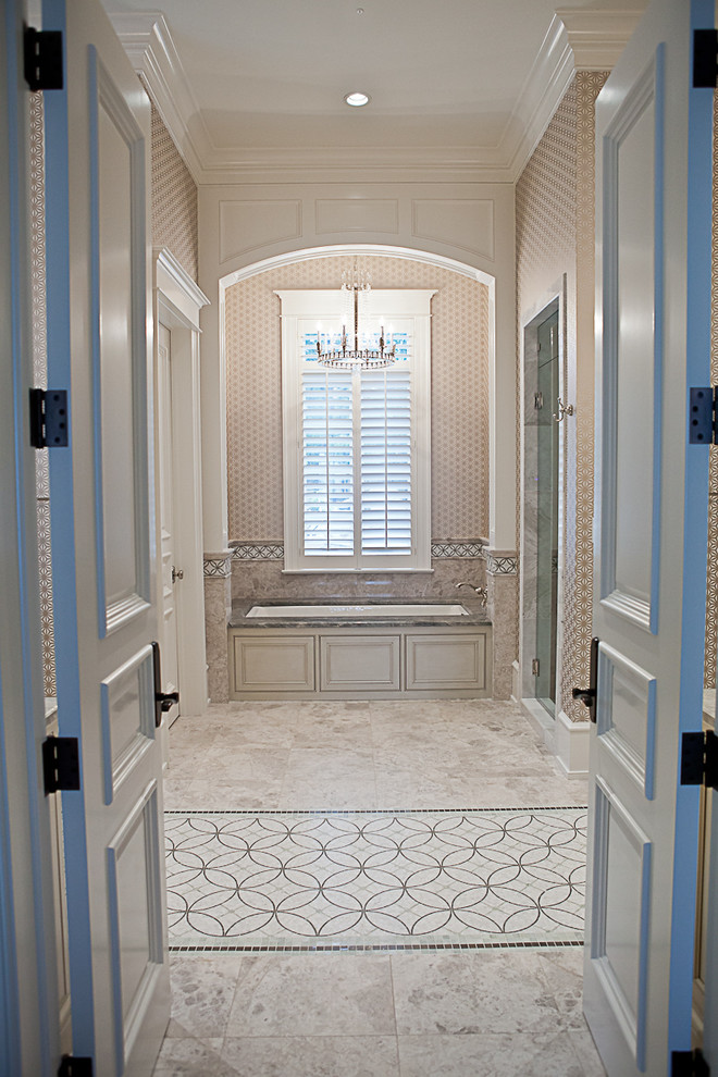Design ideas for a traditional master bathroom in Other with raised-panel cabinets, beige cabinets, an alcove tub, beige tile, marble floors, an undermount sink and granite benchtops.