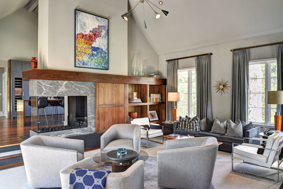 Inspiration for a 1960s living room remodel in New York with gray walls, a two-sided fireplace, a stone fireplace and no tv