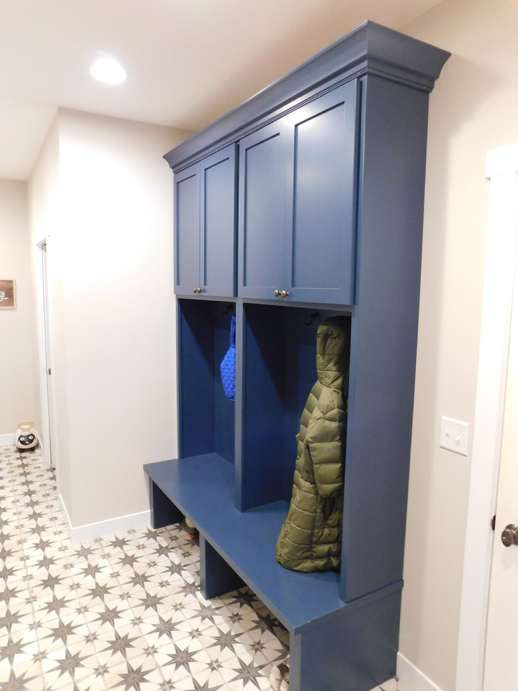 This is an example of a midcentury powder room in Other with flat-panel cabinets, blue cabinets, porcelain floors and wood benchtops.