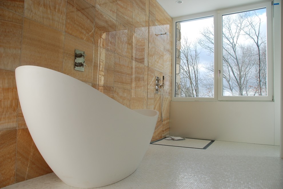 Photo of a modern bathroom in New York with a vessel sink, a freestanding tub, an open shower, a one-piece toilet, white tile and mosaic tile.
