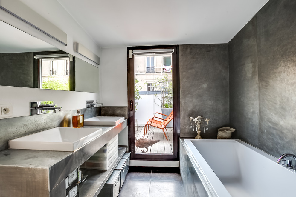 This is an example of a mid-sized contemporary bathroom in Paris with grey walls, open cabinets, grey cabinets, gray tile, metal tile, slate floors and a vessel sink.
