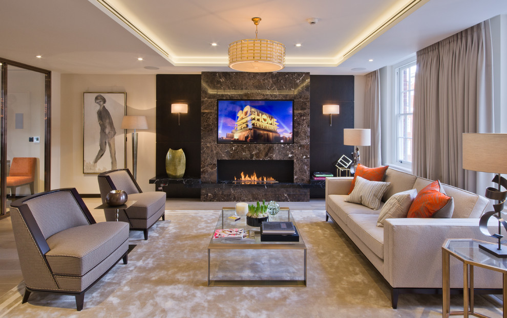 This is an example of a contemporary formal living room in London with beige walls, a standard fireplace, a wall-mounted tv and beige floor.