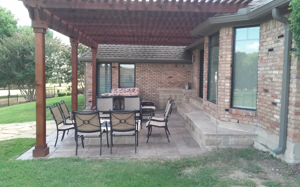 Design ideas for a mid-sized modern backyard patio in Dallas with concrete pavers and a pergola.