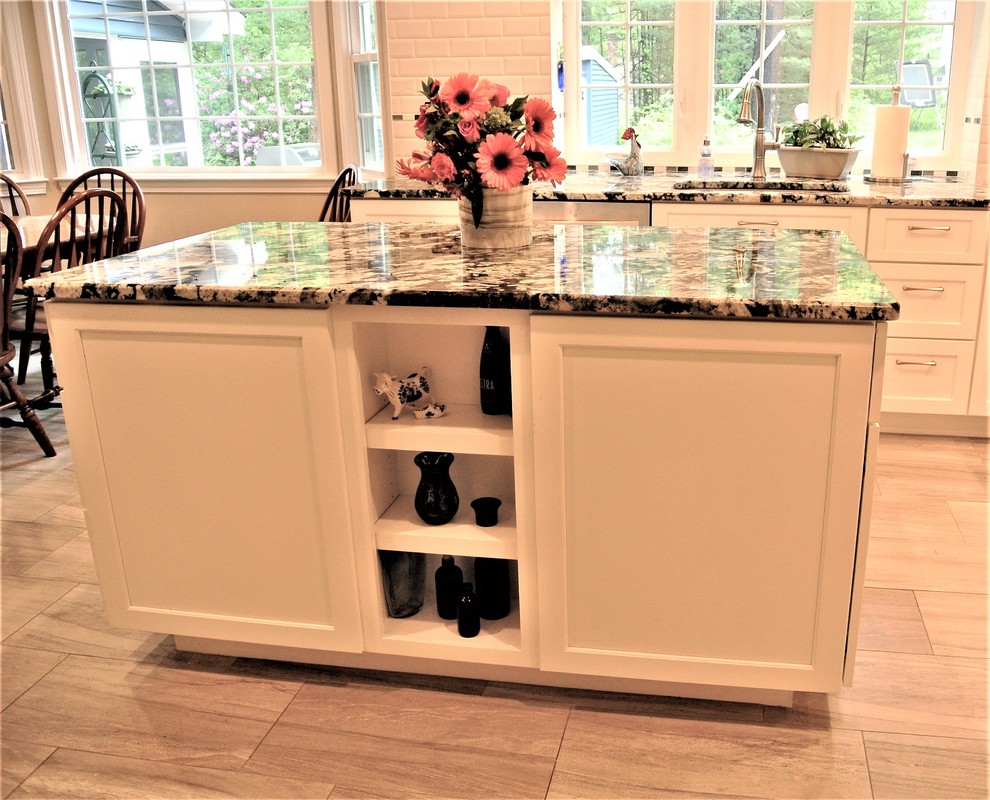 Inspiration for a transitional kitchen remodel in Boston with an undermount sink, shaker cabinets, granite countertops, subway tile backsplash, stainless steel appliances and an island