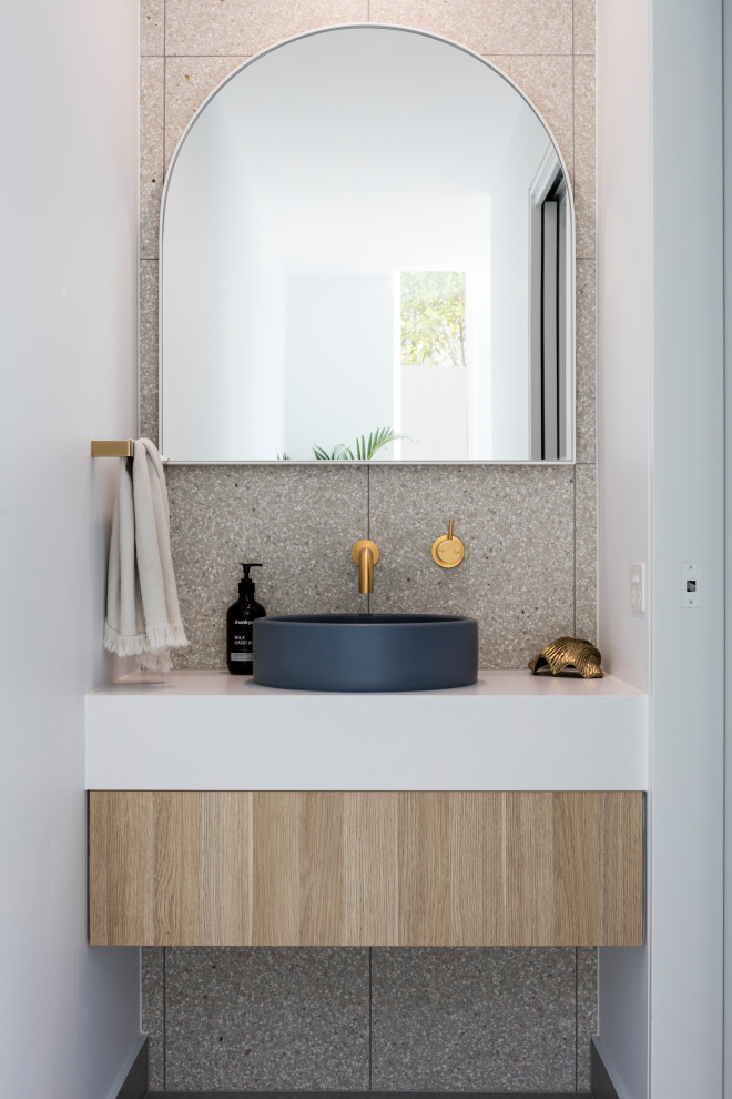 Design ideas for a beach style powder room in Sunshine Coast with flat-panel cabinets, light wood cabinets, a vessel sink, white benchtops and a floating vanity.