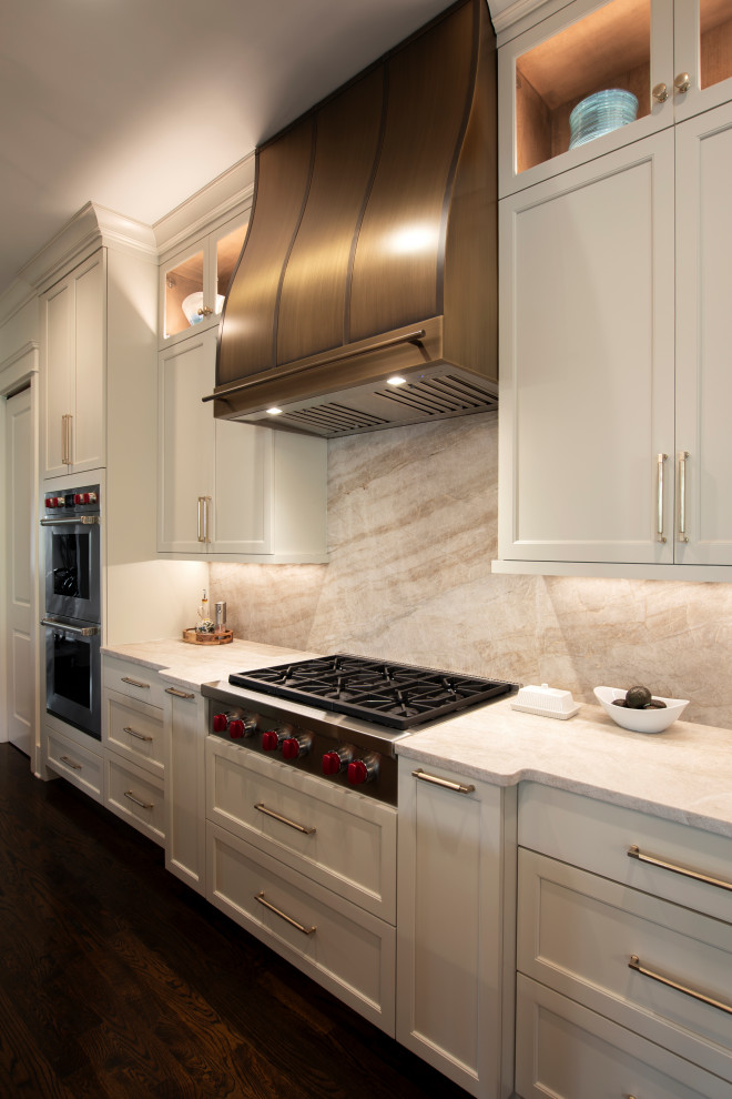 Example of a large transitional l-shaped dark wood floor and brown floor open concept kitchen design in Nashville with an undermount sink, beaded inset cabinets, white cabinets, quartzite countertops, beige backsplash, stone slab backsplash, stainless steel appliances, an island and beige countertops