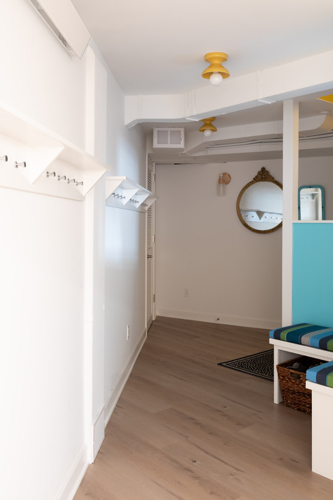 Example of a mid-sized eclectic underground vinyl floor and brown floor basement design with white walls