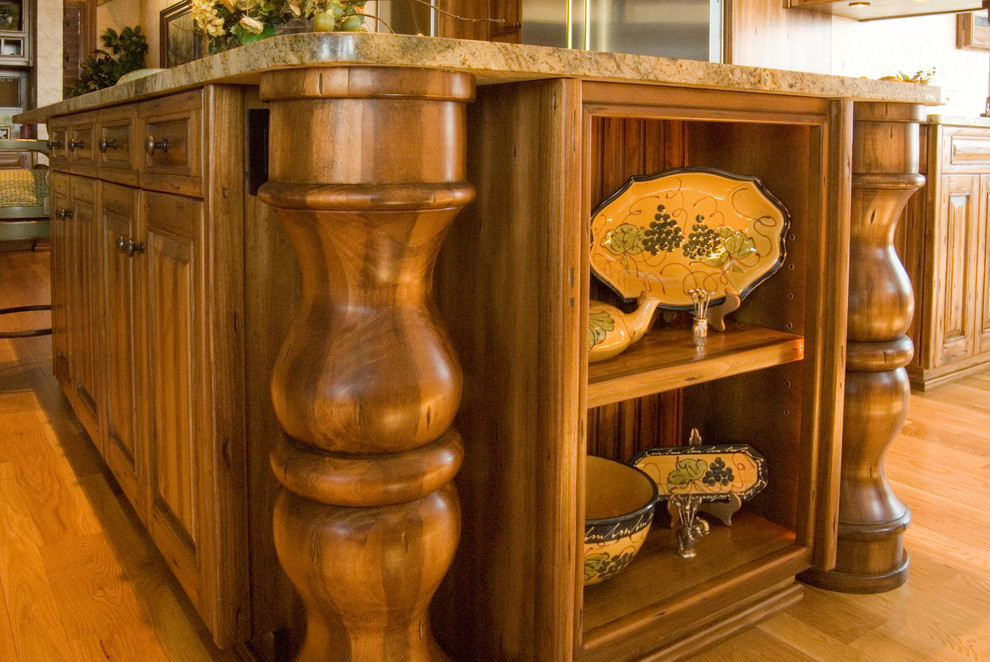 Example of a large mountain style galley eat-in kitchen design in Charlotte with raised-panel cabinets, medium tone wood cabinets, granite countertops, stainless steel appliances and an island