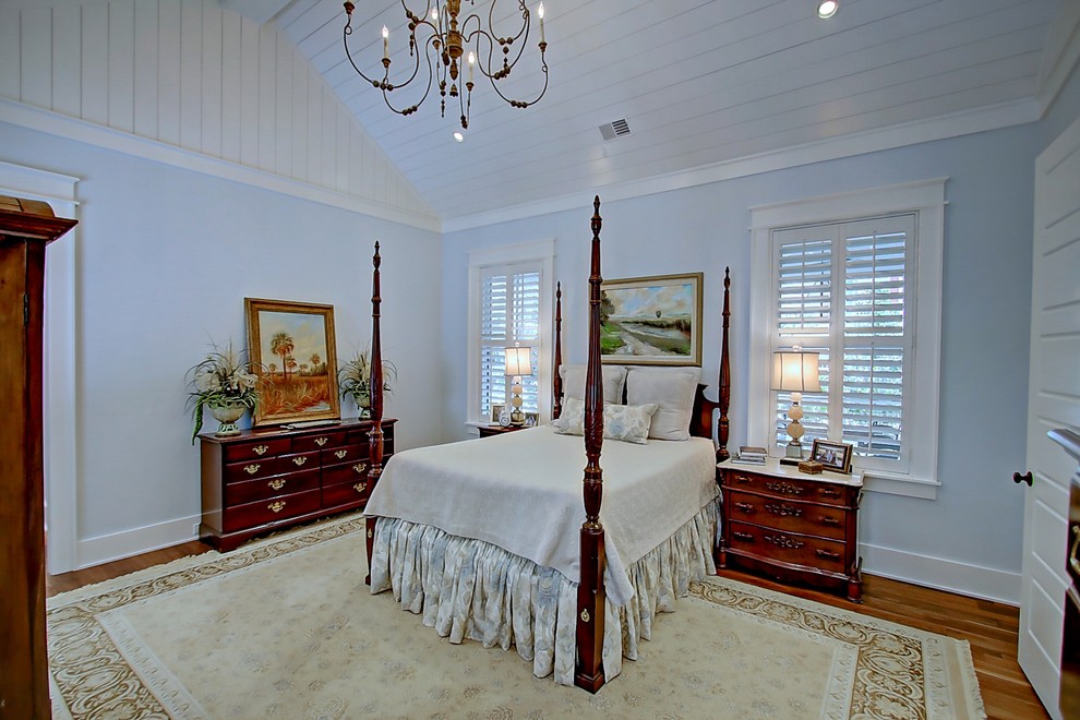 Inspiration for a mid-sized traditional master bedroom in Charleston with blue walls and medium hardwood floors.