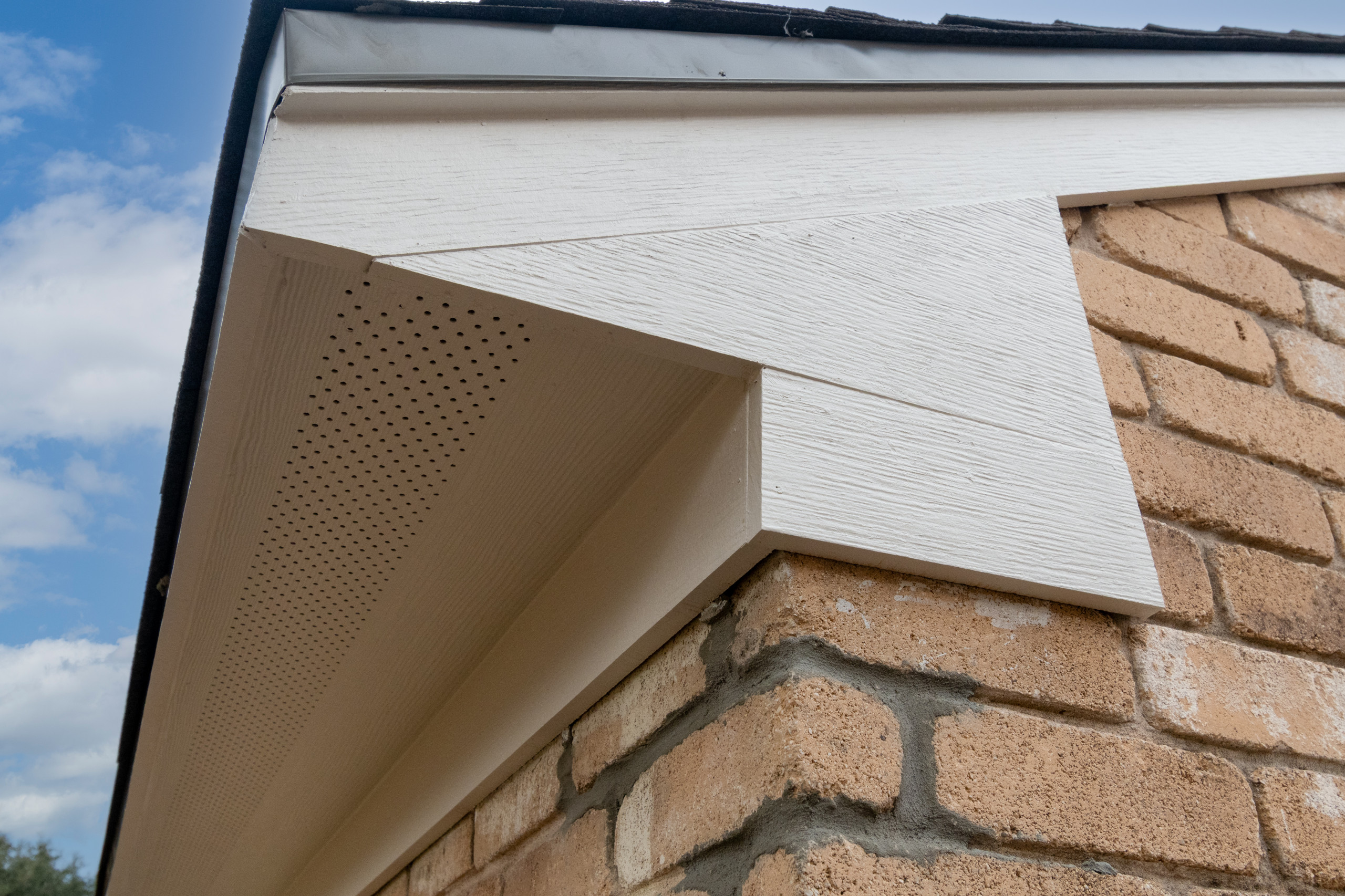 Brick Home Refresh with Hardie Siding, Fascia, Soffit, and Modern Column Replace
