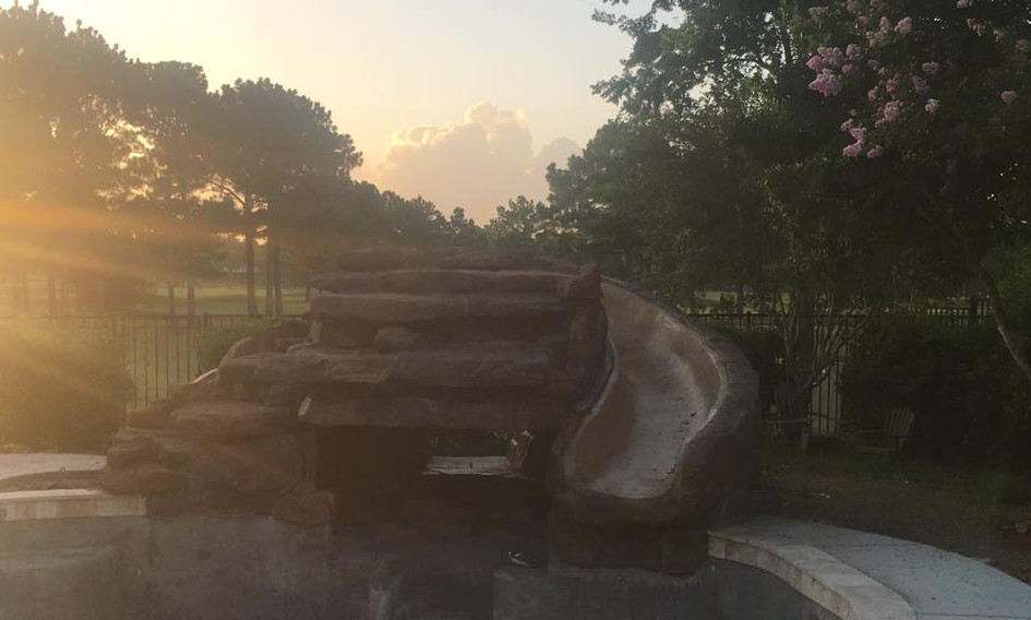 Mid-sized mountain style backyard custom-shaped and concrete paver natural water slide photo in Orange County