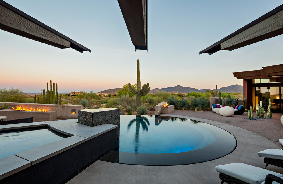 Contemporary pool in Phoenix with a hot tub.