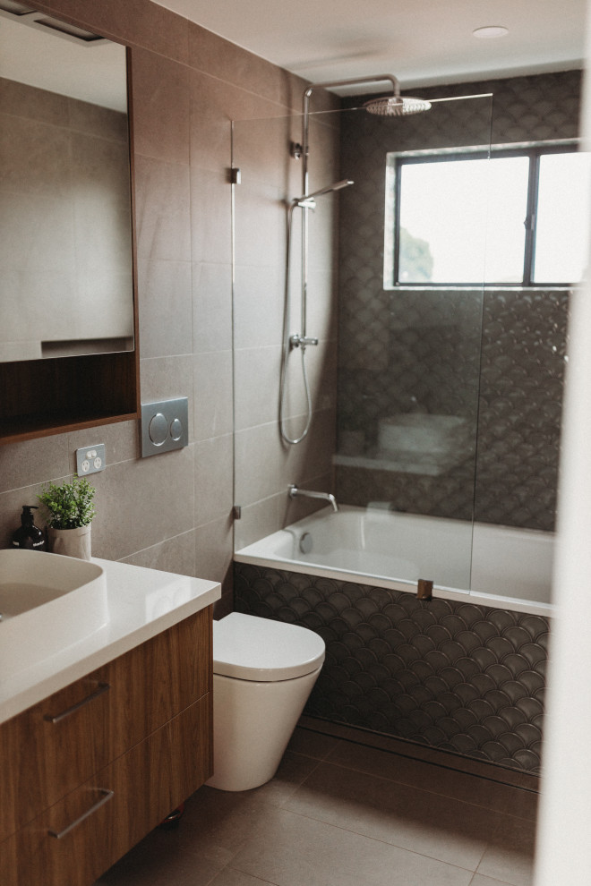This is an example of a bathroom in Sydney with grey tiles, stone tiles and yellow worktops.