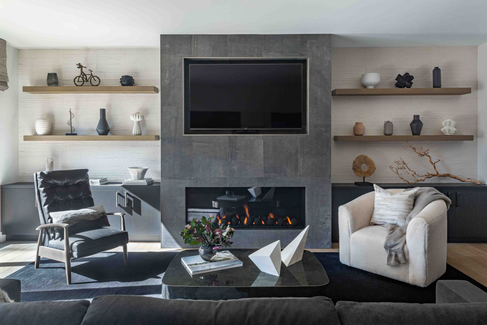 Contemporary open concept living room in San Francisco with white walls, light hardwood floors, a hanging fireplace, a tile fireplace surround, a built-in media wall and wallpaper.