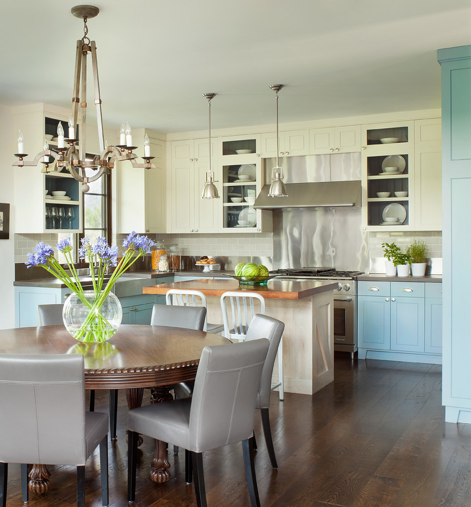 Inspiration for a country u-shaped eat-in kitchen in Denver with shaker cabinets, blue cabinets, beige splashback, subway tile splashback, stainless steel appliances, dark hardwood floors and with island.