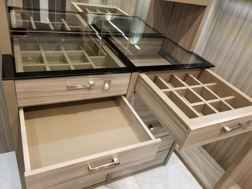Inspiration for a large transitional gender-neutral walk-in wardrobe in Miami with open cabinets, light wood cabinets, marble floors and white floor.