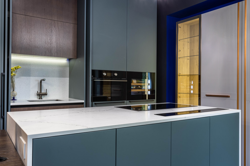Design ideas for a medium sized contemporary grey and white galley kitchen/diner in Saint Petersburg with blue cabinets, engineered stone countertops, white splashback, engineered quartz splashback, an island and white worktops.