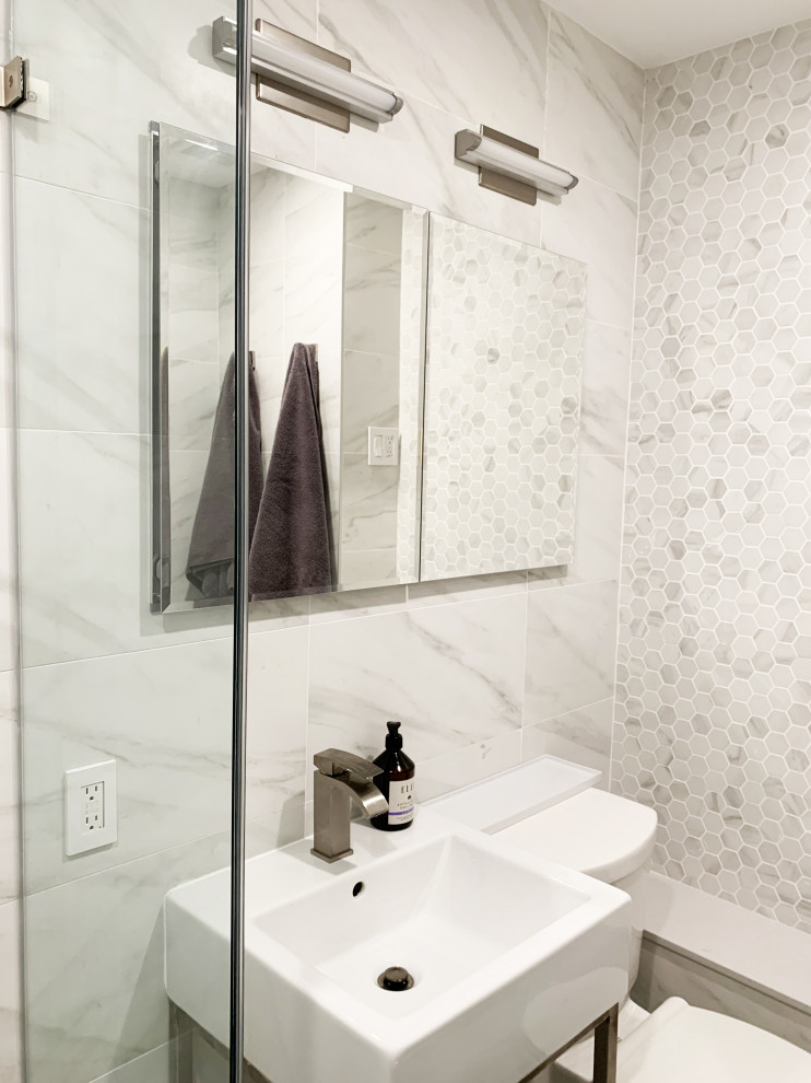 Inspiration for a small contemporary ensuite bathroom in New York with white cabinets, a one-piece toilet, white tiles, ceramic tiles, white walls, ceramic flooring, a pedestal sink, engineered stone worktops, white floors, an open shower, white worktops, a wall niche, a single sink and a freestanding vanity unit.