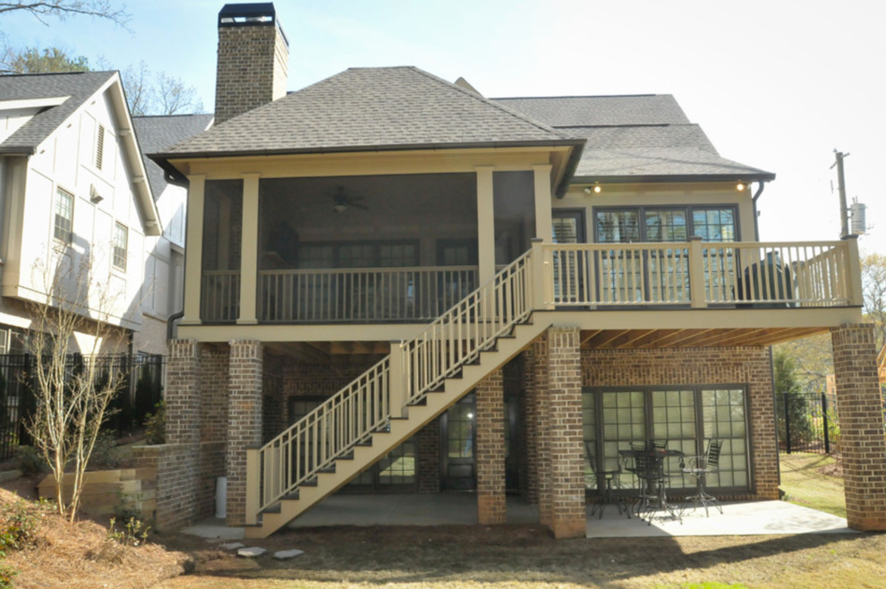 This is an example of a large transitional two-storey beige house exterior in Atlanta with mixed siding, a hip roof and a shingle roof.