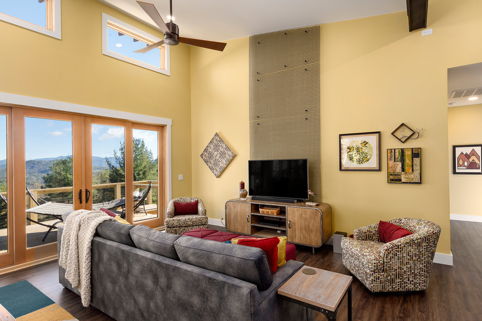 Design ideas for a country open concept family room in Other with yellow walls, dark hardwood floors, no fireplace, a freestanding tv and brown floor.