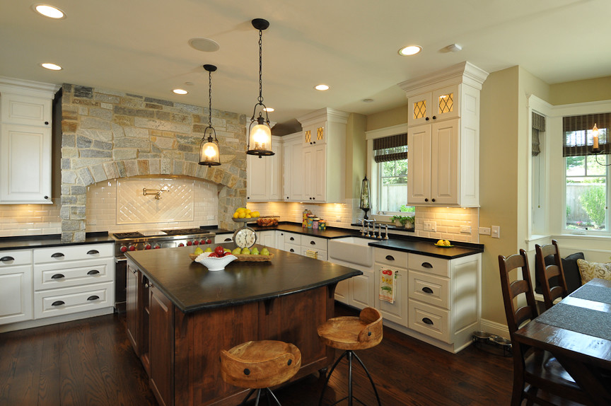 Inspiration for a rustic l-shaped eat-in kitchen remodel in Chicago with a farmhouse sink, raised-panel cabinets and white cabinets
