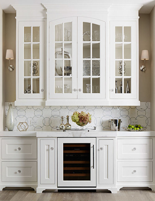 This is an example of a large transitional single-wall kitchen pantry in Chicago with an undermount sink, flat-panel cabinets, white cabinets, marble benchtops, white splashback, glass tile splashback, panelled appliances, medium hardwood floors and with island.