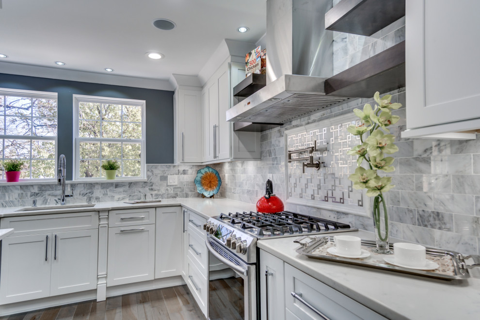 Design ideas for a large modern l-shaped eat-in kitchen in DC Metro with a drop-in sink, shaker cabinets, white cabinets, marble benchtops, grey splashback, mosaic tile splashback, stainless steel appliances, plywood floors, with island, grey floor and white benchtop.