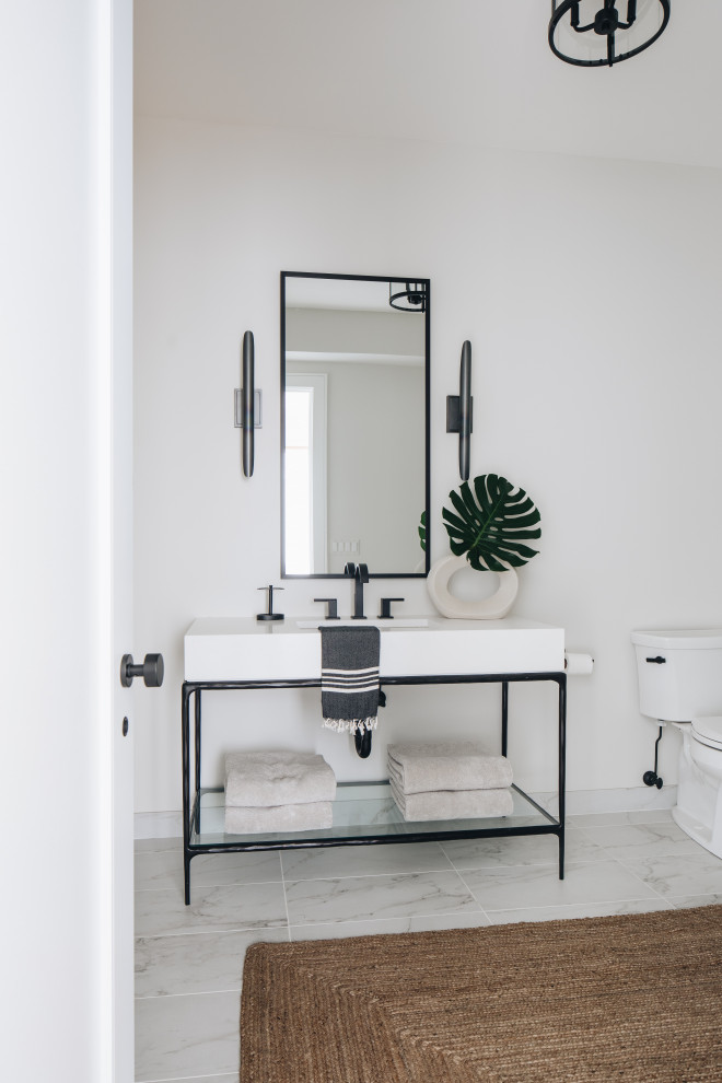 Inspiration for a mid-sized contemporary powder room in Chicago with open cabinets, grey cabinets, white walls, white floor, white benchtops and a built-in vanity.