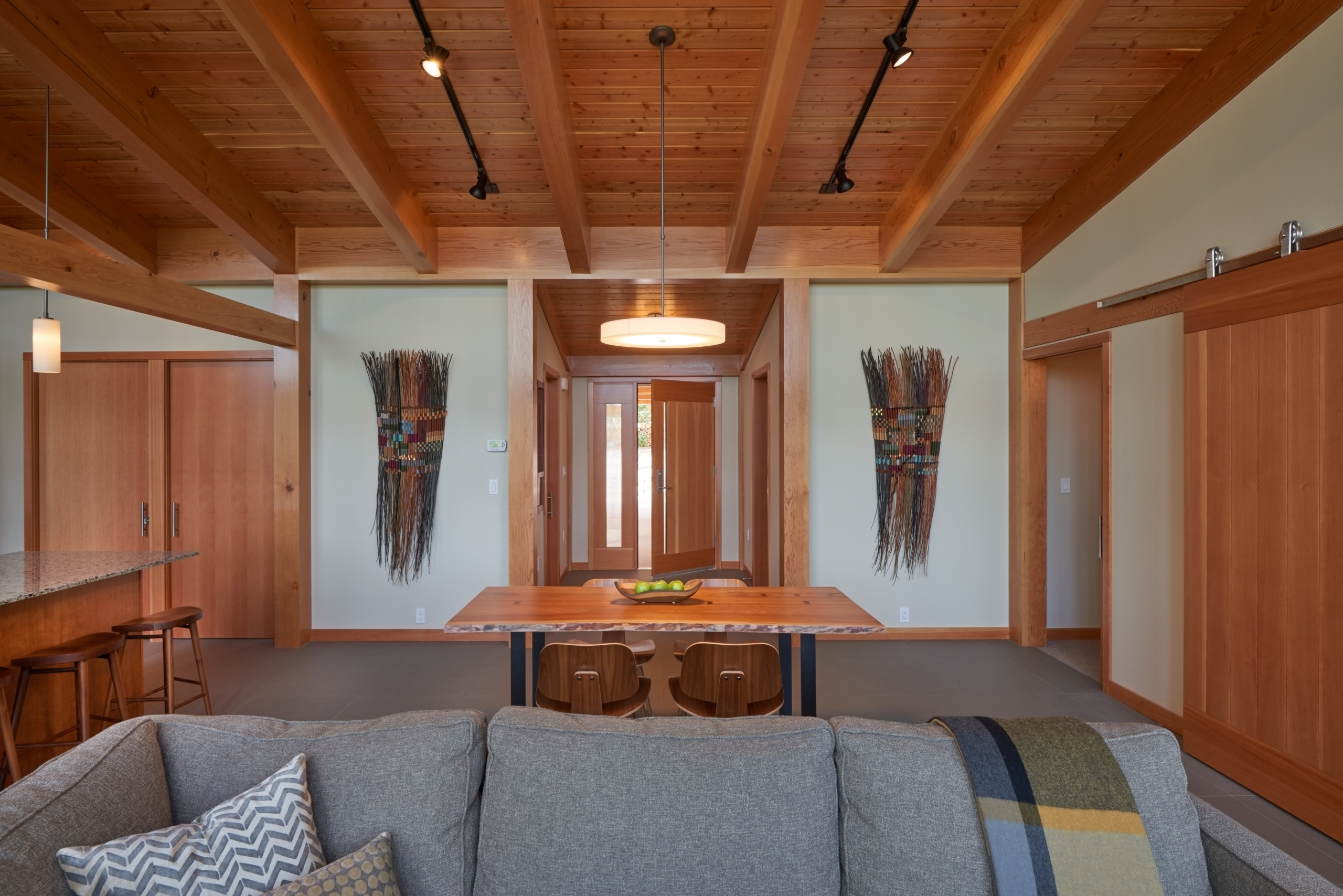 Interior view of the living and dining spaces, facing south to front entrance.