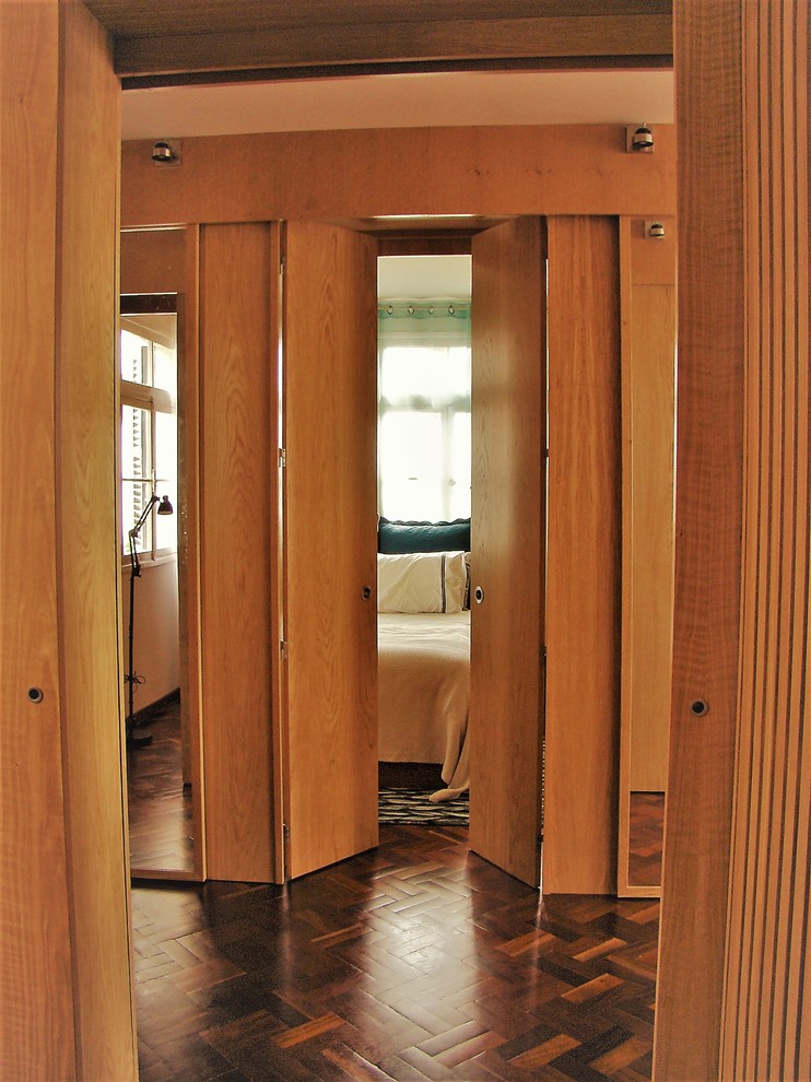 Contemporary hallway in Other with plywood floors.