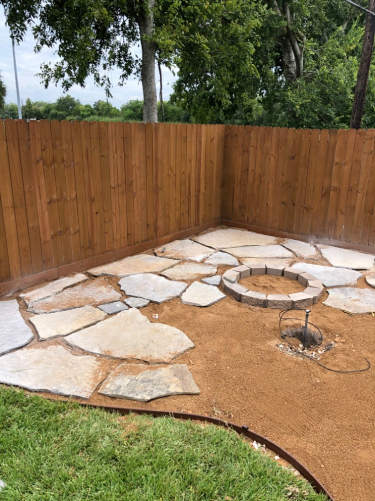 Backyard flagstone walking path with firepit and seating area