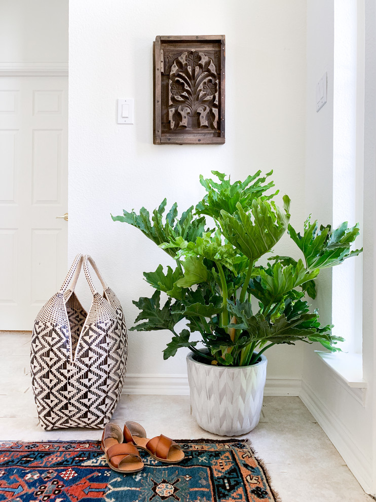 Entryway Styling Dallas – Layered Textiles & Indoor Plant | Lark Interiors - Entryway styling in a Dallas home featuring a patterned rug, woven bag, and lush indoor plant, creating a warm, welcoming moment with texture, color, and everyday functionality.