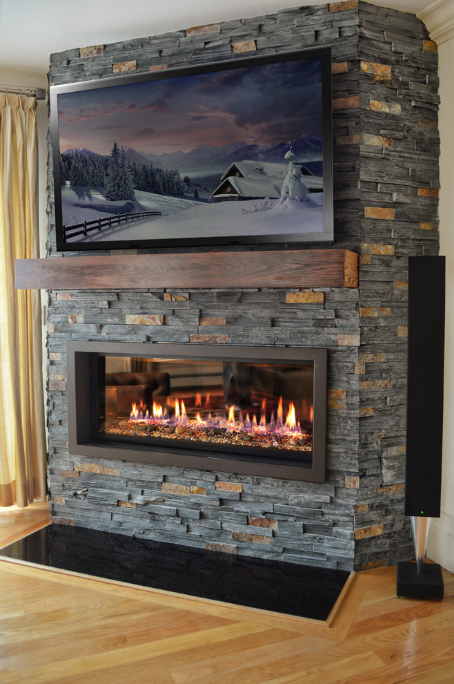 Living room - contemporary living room idea in New York with a ribbon fireplace and a stone fireplace