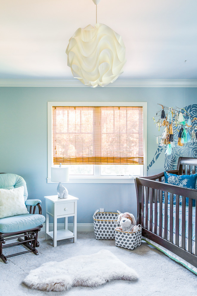 Beach style nursery in Los Angeles with blue walls, carpet and grey floor for girls.
