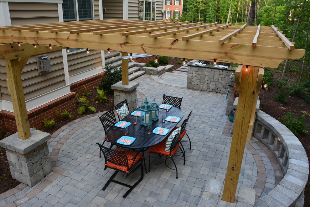 Inspiration for a mid-sized arts and crafts backyard patio in Richmond with an outdoor kitchen, concrete pavers and a pergola.
