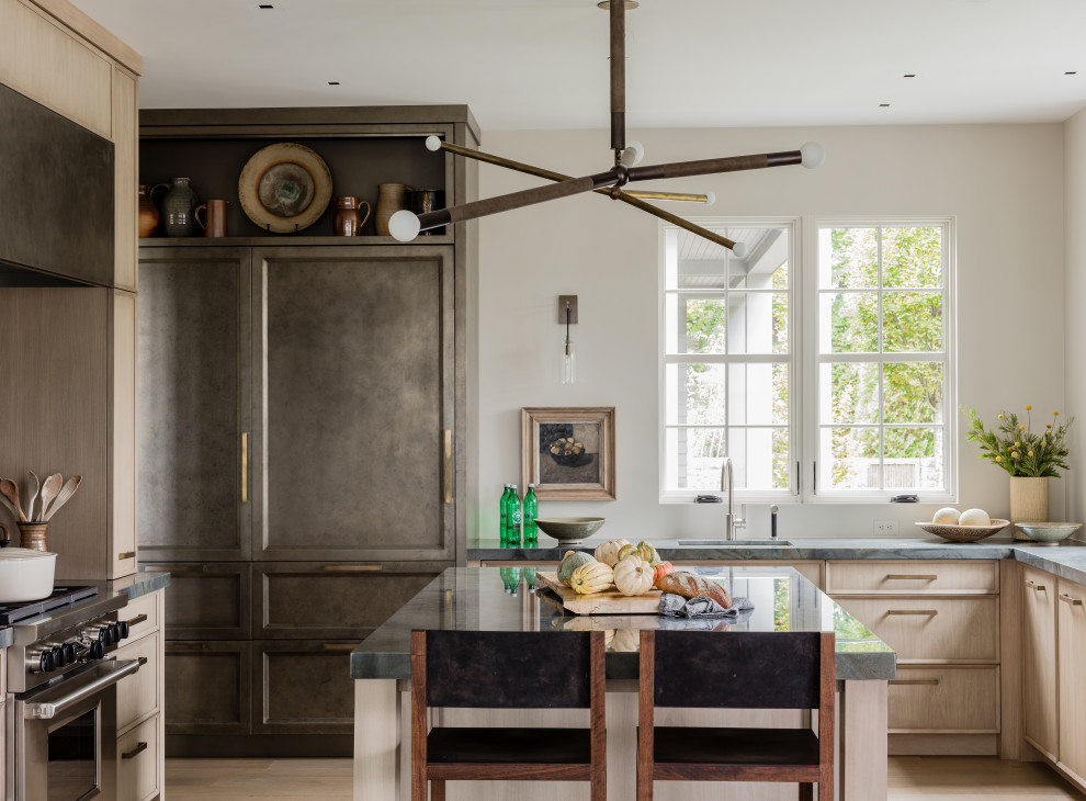 Enclosed kitchen - transitional u-shaped light wood floor and brown floor enclosed kitchen idea in Boston with an undermount sink, recessed-panel cabinets, light wood cabinets, marble countertops, white backsplash, paneled appliances, an island and multicolored countertops