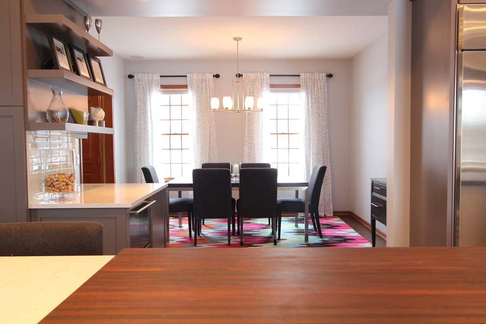 Inspiration for a large transitional medium tone wood floor great room remodel with gray walls and no fireplace