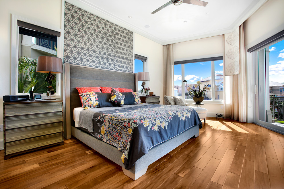 Inspiration for a tropical master bedroom in Miami with beige walls and medium hardwood floors.