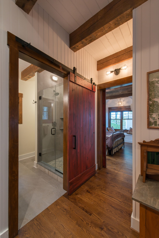 This is an example of a small country hallway in Boston with white walls and medium hardwood floors.