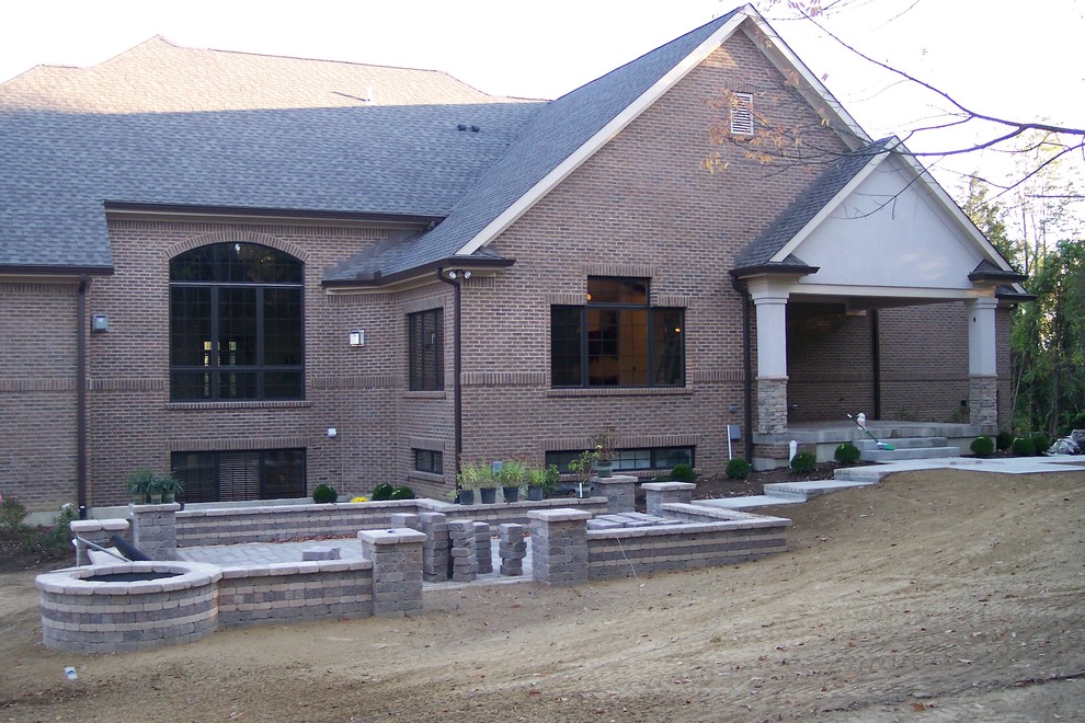 Photo of a large transitional two-storey brick brown exterior in Cincinnati with a gable roof.