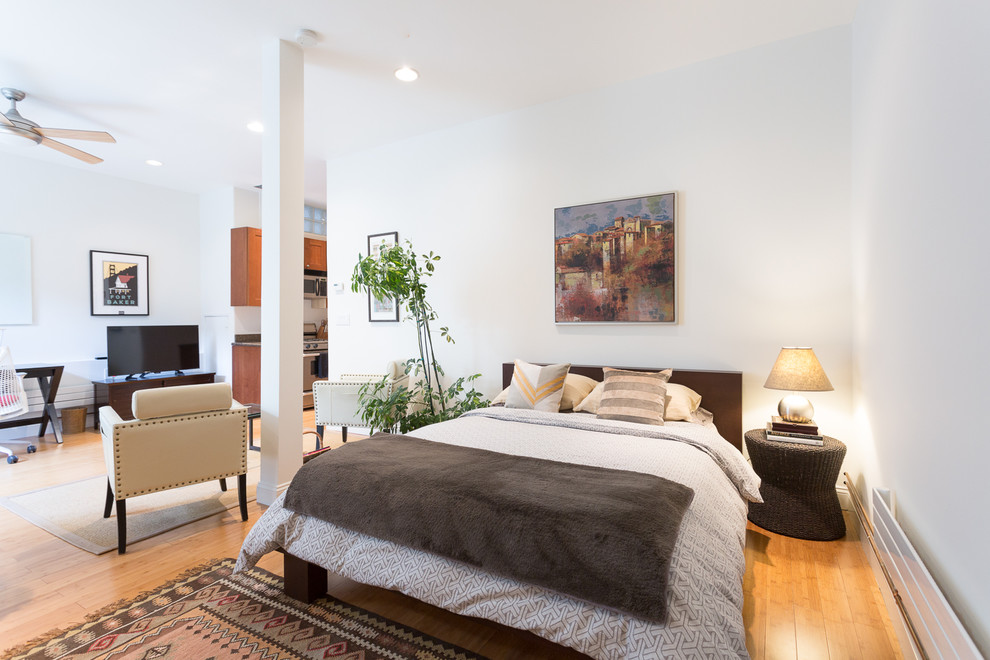 Design ideas for a transitional bedroom in San Francisco with white walls, medium hardwood floors and orange floor.