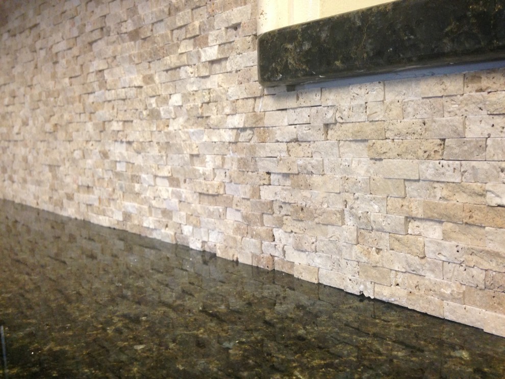 Mid-sized transitional l-shaped porcelain tile enclosed kitchen photo with an undermount sink, shaker cabinets, dark wood cabinets, granite countertops, beige backsplash, stone tile backsplash, stainless steel appliances and an island