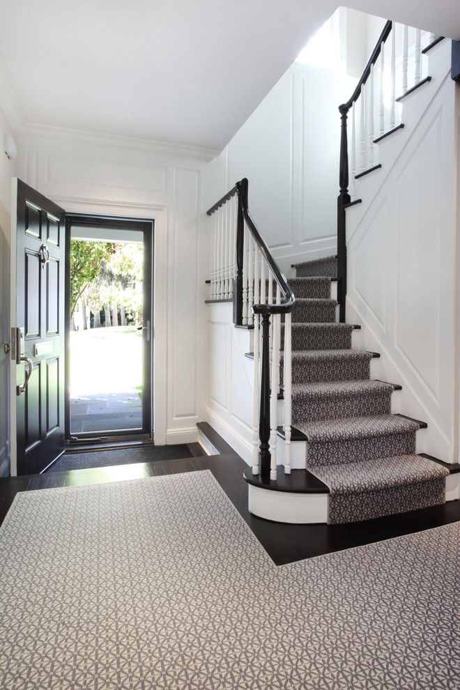 Mid-sized contemporary front door in New York with white walls, dark hardwood floors, a single front door and a dark wood front door.