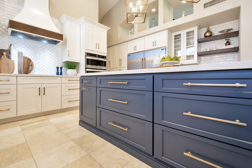Example of a large transitional u-shaped open concept kitchen design in Phoenix with a farmhouse sink, shaker cabinets, white cabinets, quartz countertops, white backsplash, subway tile backsplash, stainless steel appliances, an island and white countertops