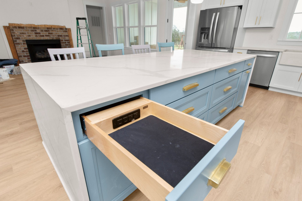 Example of a large transitional l-shaped open concept kitchen design in Richmond with a farmhouse sink, recessed-panel cabinets, quartz countertops, white backsplash, stainless steel appliances, an island and white countertops