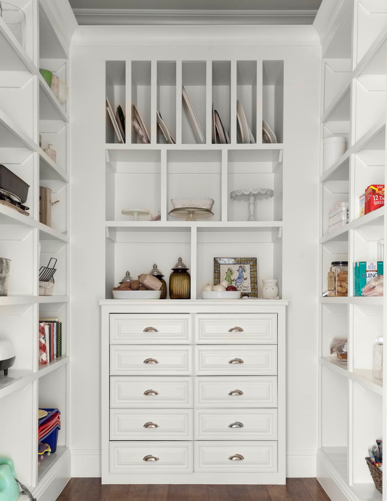 Photo of a large traditional gender-neutral walk-in wardrobe in Dallas with white cabinets, dark hardwood floors and brown floor.