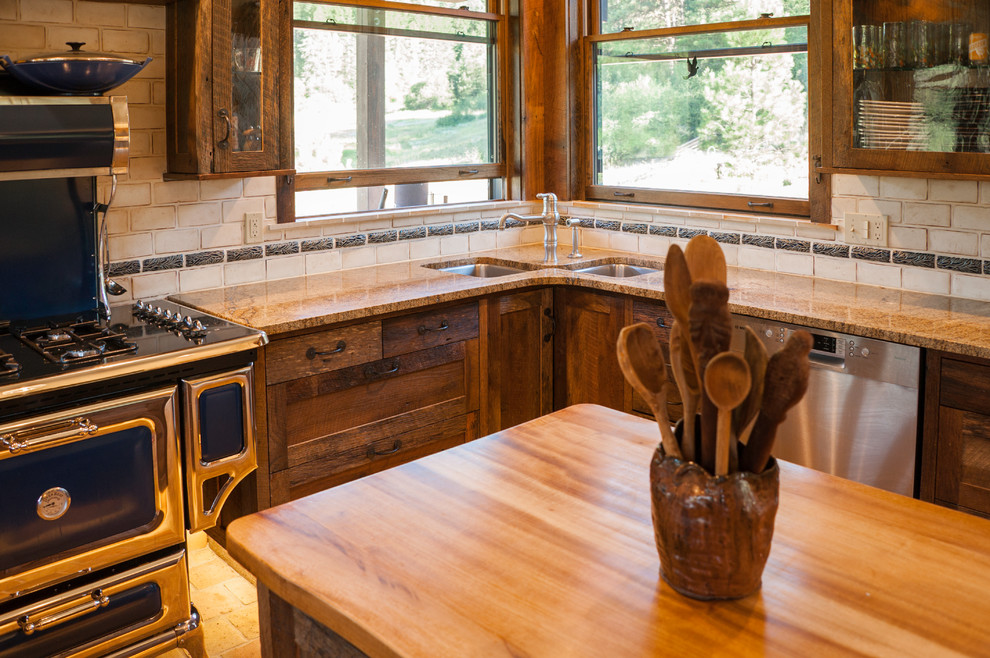 Open concept kitchen - large rustic u-shaped cement tile floor and beige floor open concept kitchen idea in Seattle with recessed-panel cabinets, granite countertops, beige backsplash, ceramic backsplash, stainless steel appliances, an island, an undermount sink and dark wood cabinets