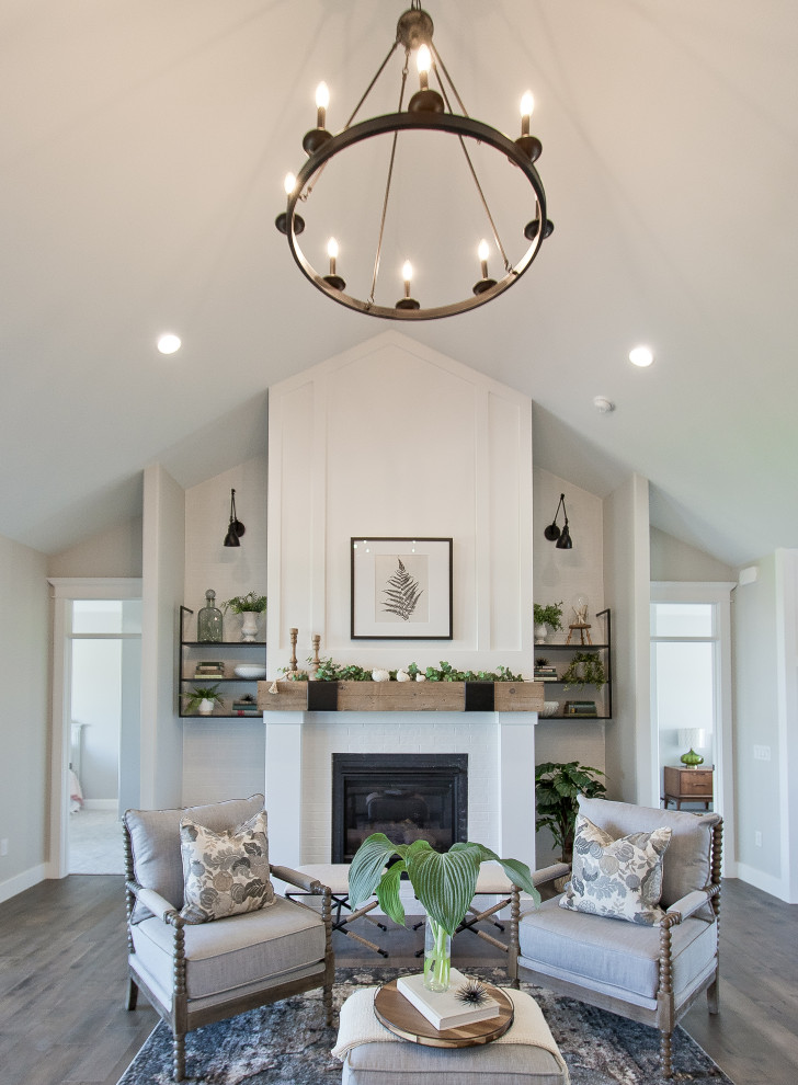 Design ideas for a country formal open concept living room with white walls, medium hardwood floors, a standard fireplace, brown floor, vaulted and planked wall panelling.