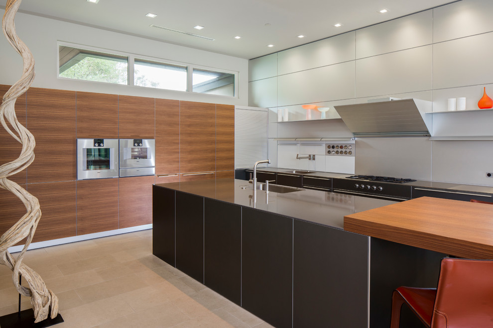 Inspiration for a contemporary kitchen in Austin with a single-bowl sink, flat-panel cabinets, medium wood cabinets, grey splashback, stainless steel appliances and with island.